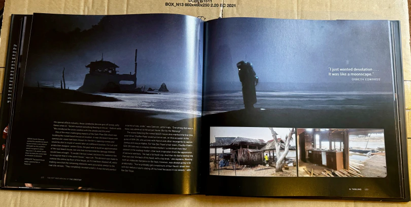 Another double-page spread of art from The Creator. A moody sea-side night scene.