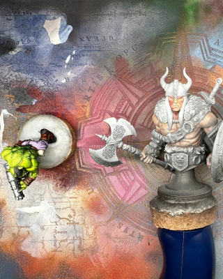 A shot from above of three minis sitting on a colourful paint-covered texture palette.