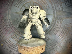 A freshly-primed 40K Terminator mini with some 3D-printed GreyTide Studios bits added for theme.
