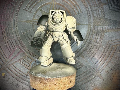A freshly-primed 40K Terminator mini with some 3D-printed GreyTide Studios bits added for theme.
