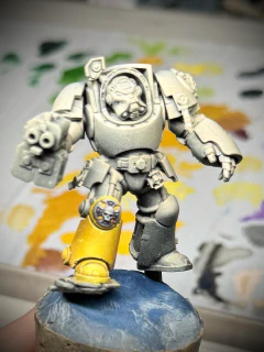 A 40K terminator miniature WIP still showing mainly primer. But his boot is yellow.
