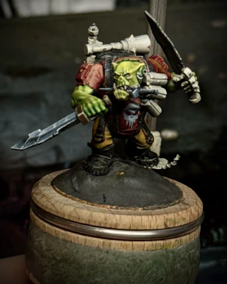 An ork ‘kommando’ model, which is approximately 90% knives, in various stages of finish. Large portions are still white primer, but he has an attempted-NMM blade mostly sketched in and a Punisher-esque logo on his red shirt. His green skin may be either too yellow or just not yellow enough, depending on my mood.