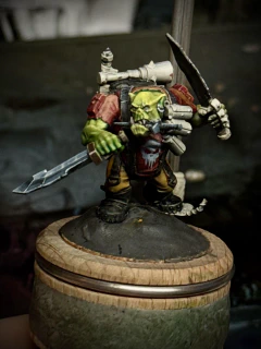 An ork ‘kommando’ model, which is approximately 90% knives, in various stages of finish. Large portions are still white primer, but he has an attempted-NMM blade mostly sketched in and a Punisher-esque logo on his red shirt. His green skin may be either too yellow or just not yellow enough, depending on my mood.
