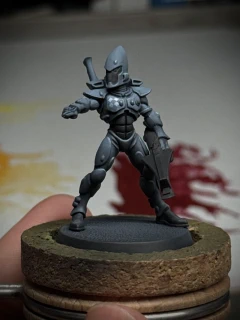 The definitely-not-a-cop blue-grey space Eldar mini from before, still just referred in blue-grey and black, but with an extra point of interest added to their right pec: a brighter blue-grey diamond pattern that reads like white.
