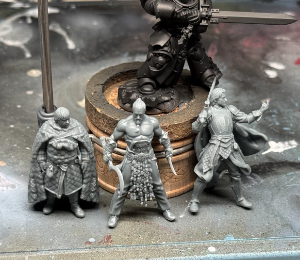 Three printed minis from the recently-concluded Game of Thrones campaign on MyMiniFactory; Sam, Drogo and Jaime pose below a hulking GW marine for scale.