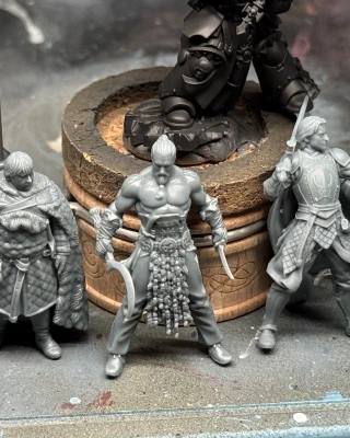 Three printed minis from the recently-concluded Game of Thrones campaign on MyMiniFactory; Sam, Drogo and Jaime pose below a hulking GW marine for scale.