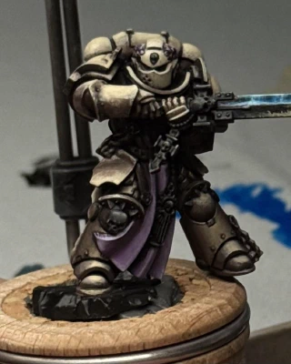 An attempt at a beaten-up but still shiny Space Metal on the sword, reflecting brighter blue light from above and some off-stage possibly-firey orange from below.