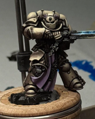 An attempt at a beaten-up but still shiny Space Metal on the sword, reflecting brighter blue light from above and some off-stage possibly-firey orange from below.