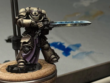 An attempt at a beaten-up but still shiny Space Metal on the sword, reflecting brighter blue light from above and some off-stage possibly-firey orange from below.