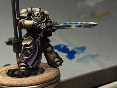 An attempt at a beaten-up but still shiny Space Metal on the sword, reflecting brighter blue light from above and some off-stage possibly-firey orange from below.
