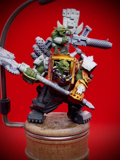 Our friendly Ork chum now has some ‘yellow’ (orange, wearing many hats) on his hoodie and a start at some NMM on his dentures. The denture adventure left a visible wound above one eyebrow. As can happen.