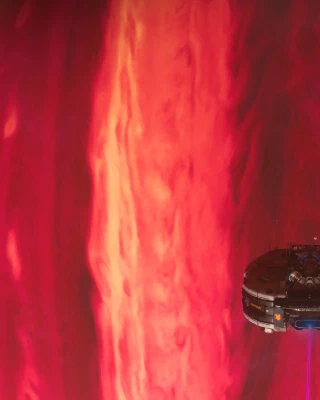 A little space doodad flies far above the surface of a gas giant, over dramatic rivers of red and brown clouds.