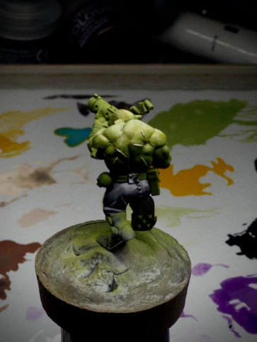 Purple trousers and a darkly reflective belt gubbin (can’t be a buckle, it’s on the wrong side. And appears to have rivets) have been added, unnecessarily accentuating the backside.