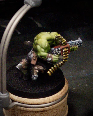 Imagine an awkward, tiny cuboid shape with inset areas and raised rivet features, imagine it pressed up against an expansive chest and shoulder’s worth of delicately blended skin that you _definitely_ don’t want to touch with either black or white paint, then imagine painting 1mm-wide black and white squares on it with a size 000 PAINT BRUSH, you fool.