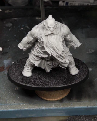 A whole new child appears! Bearded and girthy! Its absurd size in comparison with gaming minis is subtly hinted at by both cramming it inside the largest Rathcore painting handle, tacked to a painting base probably intended for horses*, and standing it next to an industry-standard reference pot of Vallejo plastic putty.

*🤷‍♂️