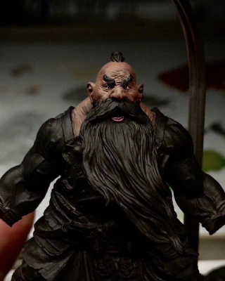 A mostly black-primed chonky dorf. If you squint, you can see his squint. The head, lack of neck, and trapezius have an initial brown basecoat applied. This could take a while. And that’s coming from _this_ guy.