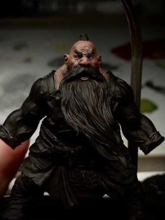 A mostly black-primed chonky dorf. If you squint, you can see his squint. The head, lack of neck, and trapezius have an initial brown basecoat applied. This could take a while. And that’s coming from _this_ guy.