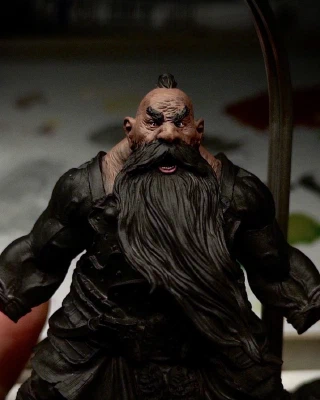 A mostly black-primed chonky dorf. If you squint, you can see his squint. The head, lack of neck, and trapezius have an initial brown basecoat applied. This could take a while. And that’s coming from _this_ guy.