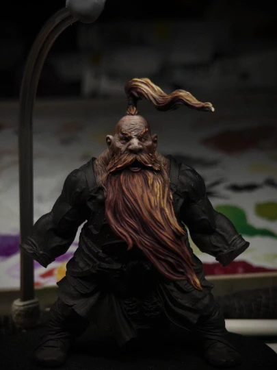 A topknot has been attached to the head of the mini, the same red-to-orange highlight pass has been applied.