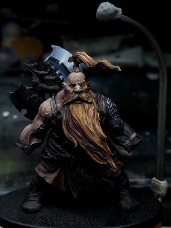 Look. We can all agree that the tattoo is a huge and life-altering mistake that I’ll be paying for forever. So why not compound it with a massive ‘steel’ axe that will take just as long?

In this shot the upper blade has been sketched in, it’s a bit too blue and not quite bright enough at the brightest point. It also definitely reads a bit ‘fantasy comic illustration’ rather than ‘real’. Which isn’t bad necessarily, but doesn’t quite fit the rest of the mini.