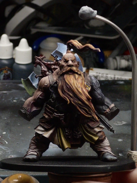 Barely visible on the mini for the time it took, we have some paint on his frilly linen undergarments and yellow crotch scarves (there are presumably more manly names for these things?) as well as stark lighting applied to boot and wraps, with some multicoloured highlights on the chest and belt armour panels.

The background is a jumbled horror of paint pots, tubes, sanding sticks and masking tape.