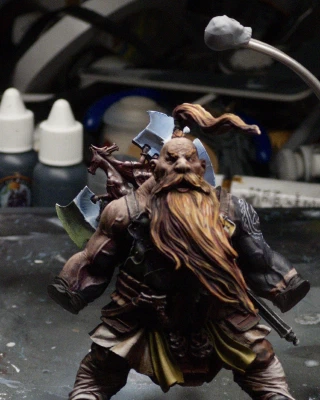 Barely visible on the mini for the time it took, we have some paint on his frilly linen undergarments and yellow crotch scarves (there are presumably more manly names for these things?) as well as stark lighting applied to boot and wraps, with some multicoloured highlights on the chest and belt armour panels.

The background is a jumbled horror of paint pots, tubes, sanding sticks and masking tape.