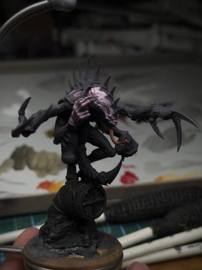 A red-yellow tongue and some matching fingernails join a slightly smoothed-out pink-purple face blend with similar skin-tones applied to one hand.