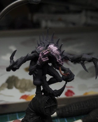 A red-yellow tongue and some matching fingernails join a slightly smoothed-out pink-purple face blend with similar skin-tones applied to one hand.