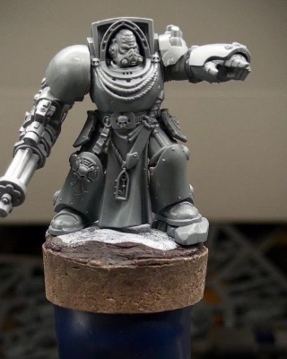 A friendly giant space wizard arrives on the painting handle, gatling gun safely lowered, admonishing subject or subjects unseen with a raised finger. He’s wearing what appears to be a cooking apron and has presumably been interrupted while baking biscuits.